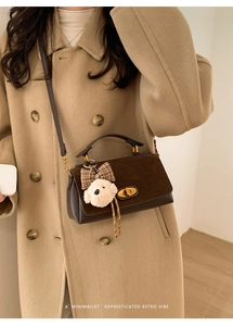 Minimalist dark brown crossbody bag with matte flap and cute plush dog charm detail