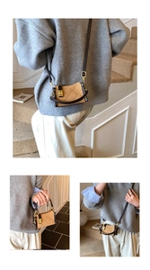 Detail of khaki quilted crossbody bag with brown leather trim and golden clasp buckle