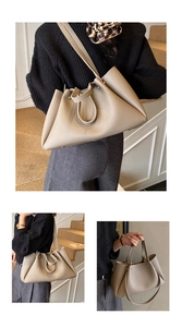 Detail of beige pebbled leather tote featuring unique folded sides and dual straps