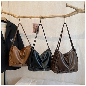 Detailed view of large retro shoulder bags in brown, black, and coffee PU leather
