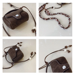 Detail of vintage brown mini crossbody bag with wooden beads and woven ethnic strap