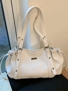 Retro white leather tote bag with side drawstrings and metal plate in 45-degree view