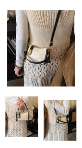 Detail of cream quilted bag with black contrast trim and gold metal lock hardware