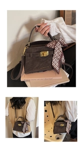 Detail of dark brown leather handbag with gold hardware, silk scarf and shoulder strap