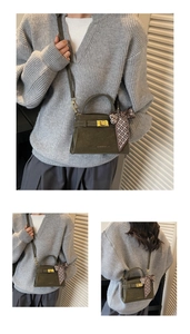 Detail of olive green suede handbag featuring a gold twist lock and silk scarf decor