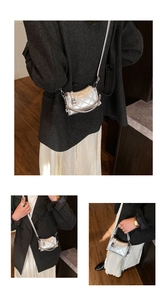 Close-up of silver quilted crossbody bag with metallic finish and metal turn-lock closure