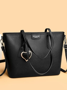 Black lychee grain large tote bag with dual handles, shoulder strap, and heart pendant