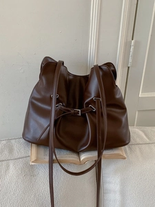 Retro pleated dark brown leather tote bag with stylish shoulder strap and minimalist buckle