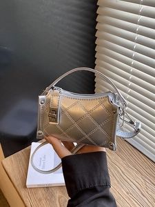 Silver quilted metallic handbag with chic rhombic patterns and silver handle shown held