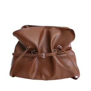 Brown pleated underarm tote bag with adjustable shoulder strap and minimalist design