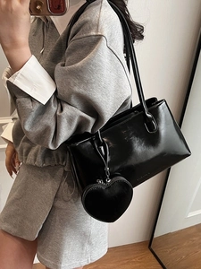 Glossy black patent leather shoulder bag for women with heart charm and slim straps