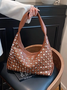 Brown leather hobo handbag with silver metal rivets and a stylish crescent moon shape