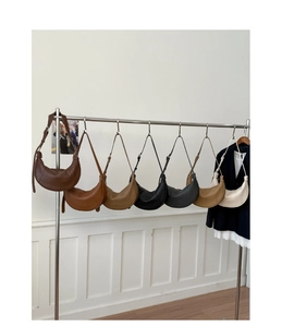 Detailed display of crescent-shaped leather shoulder bags in seven various classic colors