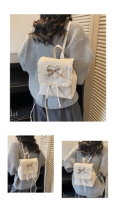 Detail of beige mini backpack featuring pearl heart, ribbon, and delicate lace trim