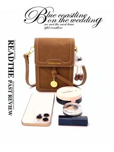 Brown leather crossbody bag showing internal capacity with phone and cosmetics