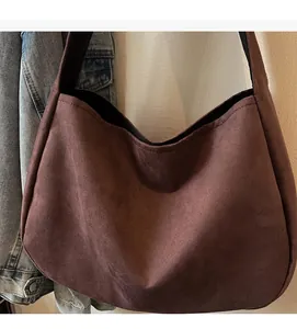 Close-up of caramel brown frosted suede tote bag showing soft texture and wide strap