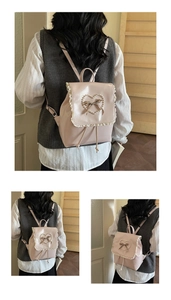 Detail of pink PU leather backpack with pearl heart, lace trim, and plaid bow accent