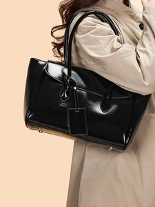 Classic black glossy patent leather tote bag with double top handles and sleek mirror finish