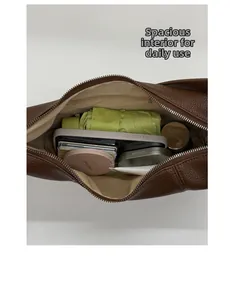 Spacious interior of dark brown leather tote bag with daily essentials and zipper pocket