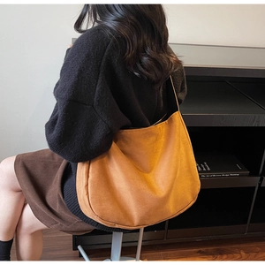 Close-up of caramel brown faux suede tote bag showing soft texture and spacious design