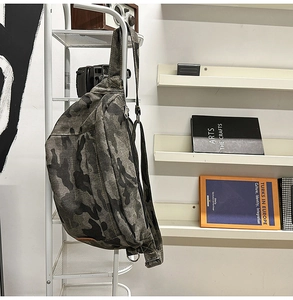 Close-up of camouflage chest bag showing durable canvas texture and adjustable buckle
