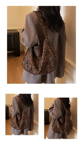 Detailed view of casual hobo bag with classic leopard print canvas and wide shoulder strap