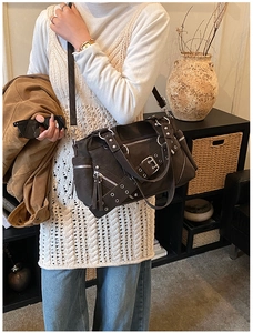 Detail view of vintage punk tote bag showing multiple zipper pockets and metal buckles