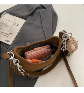 Internal view of brown crescent shoulder bag showing space for wallet and lipstick