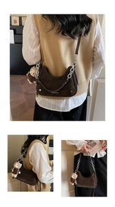 Detail of dark brown corduroy hobo bag with silver chain and cute teddy bear charm