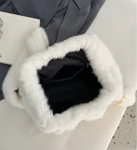 Close-up of fluffy white faux fur bag interior featuring black lining and zipper pocket