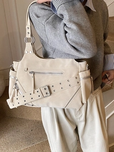 Chic cream leather bucket bag with silver studs and multi-zipper motorcycle style details