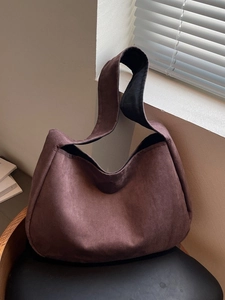 Large dark brown frosted suede hobo bag shown in a warm minimalist home setting