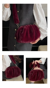 Detailed view of burgundy faux fur cloud bag featuring soft pleats and plush shoulder strap