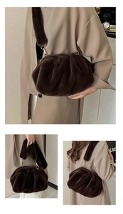 Detail view of brown faux fur cloud bag with soft pleats and golden metal buckles