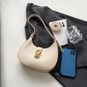 Chic beige half-moon underarm bag with gold metal lock and leather texture