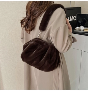 Detail of the soft dark brown plush shoulder bag with pleated texture and wide strap