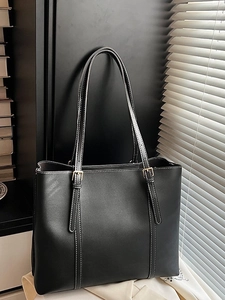 Vintage black tote bag in premium faux leather with white contrast stitching and gold buckles