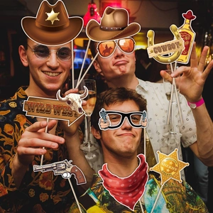 Western cowboy themed party photo booth props set with hats, badges and revolvers
