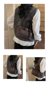 Detailed view of chocolate brown glossy leather bucket bag with metallic belt and woven charm