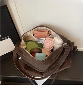 Interior view showing the large capacity and pockets of the dark brown leather tote bag