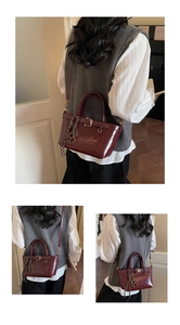 Detailed views of a vintage dark red leather handbag with gold charms and shoulder strap