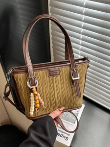 Sac seau rétro vert moutarde plissé avec bordure en cuir marron et pendentif perlé