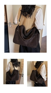 Detail of sunflower embossed pattern on dark brown suede tote bag with wide strap