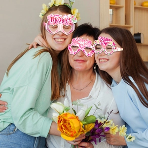 Three happy women wearing pink floral Mother's Day paper party glasses props