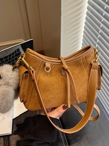Brown suede faux leather shoulder bag with drawstring detail and plush charm
