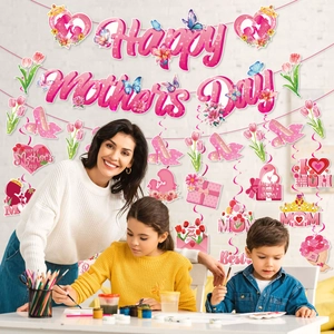 Happy Mother's Day party decoration set with pink banner and hanging swirls on a wall