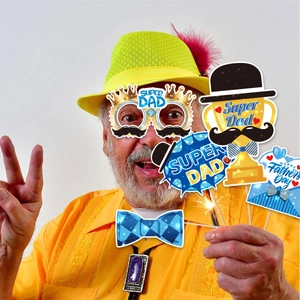 Close-up of Father's Day party props including a Super Dad trophy and blue bowtie accessories
