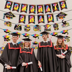 Detail of Congrats Grad 2026 banners and colorful spiral hangings in a party setting