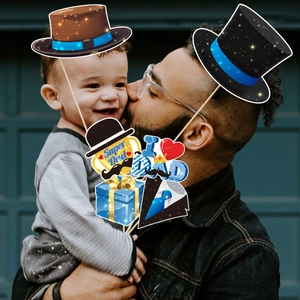 Father's Day photo booth props set featuring Super Dad signs and hats for party fun