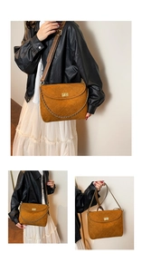 Detail of quilted brown suede tote bag with golden twist lock and luxury chain strap